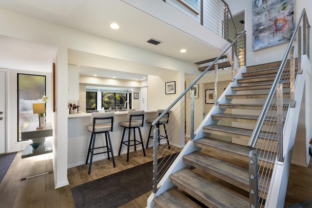 stairs with wood-type flooring