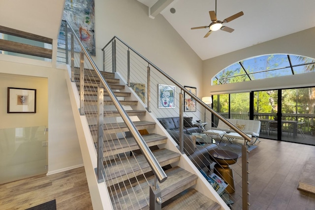 living room with hardwood / wood-style floors, ceiling fan, french doors, high vaulted ceiling, and beam ceiling