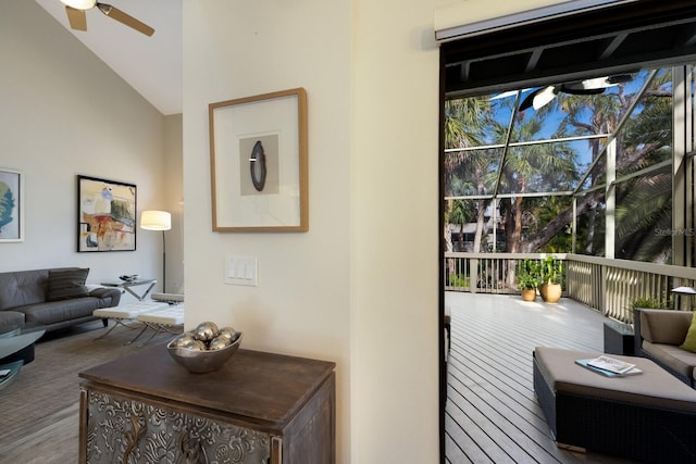 entryway featuring ceiling fan, wood-type flooring, and lofted ceiling