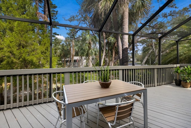 wooden deck featuring glass enclosure