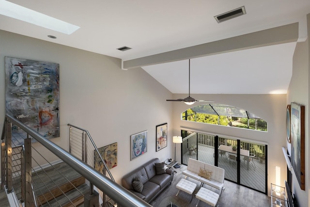 living room featuring ceiling fan, hardwood / wood-style flooring, and lofted ceiling with skylight