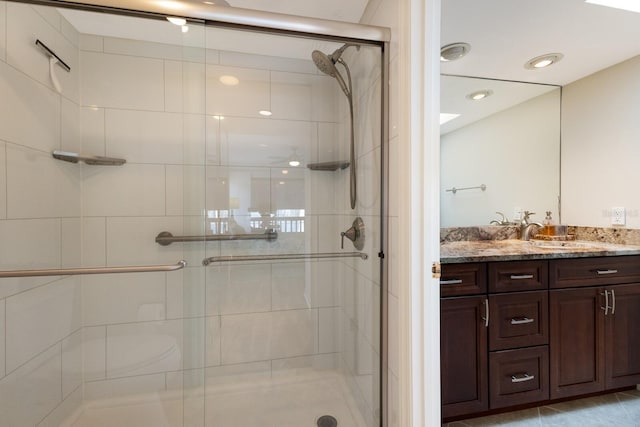 bathroom with an enclosed shower and vanity