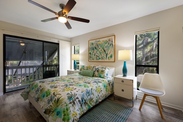 bedroom with ceiling fan, dark hardwood / wood-style flooring, and multiple windows