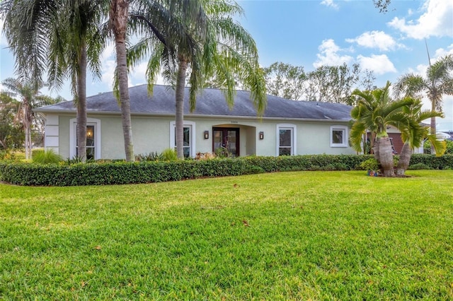 ranch-style home featuring a front lawn