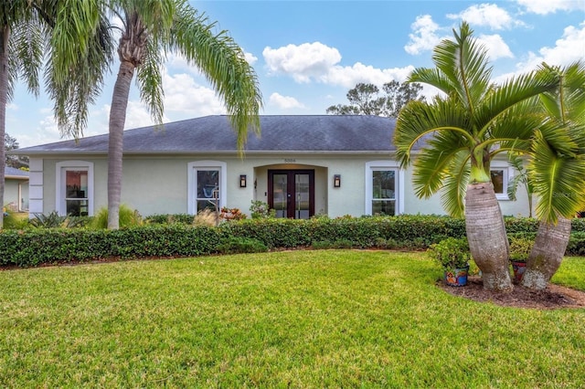 ranch-style house featuring french doors and a front yard