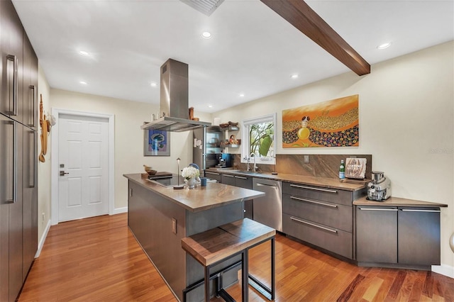 kitchen featuring island exhaust hood, a kitchen island with sink, light wood-type flooring, stainless steel dishwasher, and black electric cooktop