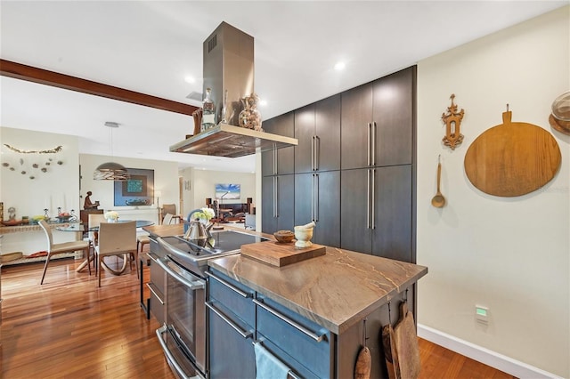 kitchen featuring dark hardwood / wood-style floors, a center island, hanging light fixtures, stainless steel electric range oven, and island range hood