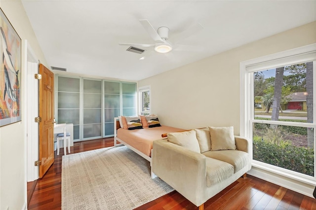 bedroom with ceiling fan and dark hardwood / wood-style flooring