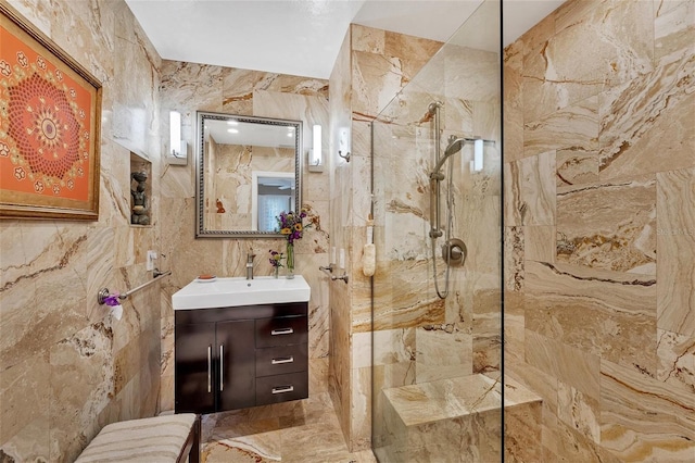 bathroom with vanity, tile walls, and tiled shower