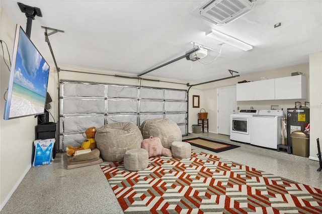 garage featuring electric water heater, washing machine and dryer, and a garage door opener