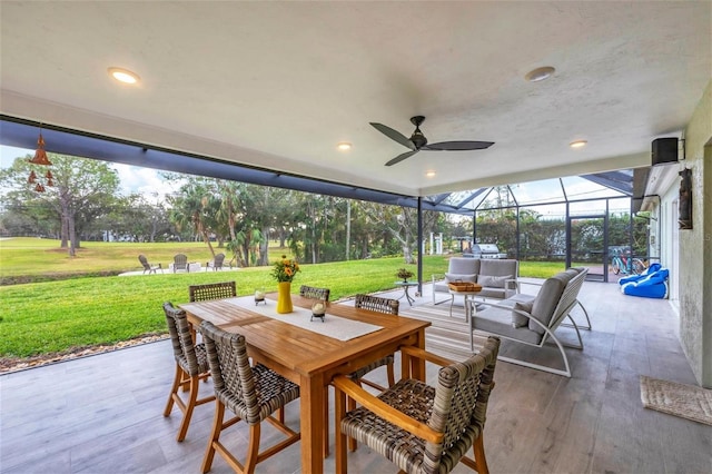 view of patio / terrace featuring ceiling fan, a lanai, and an outdoor living space