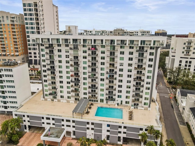 view of building exterior featuring a community pool