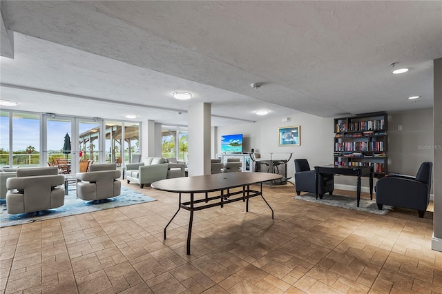 recreation room with a textured ceiling