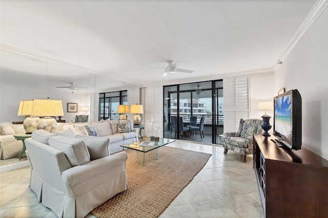 living room with ceiling fan, plenty of natural light, light tile patterned flooring, crown molding, and expansive windows