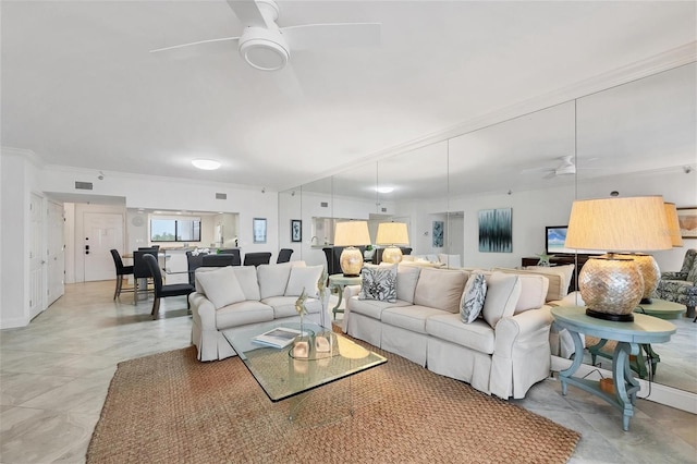 living room featuring ceiling fan and crown molding