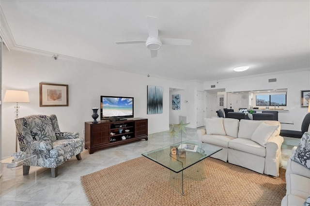 living room featuring ceiling fan and ornamental molding