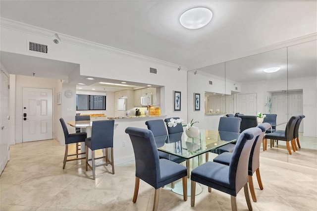 dining area featuring crown molding