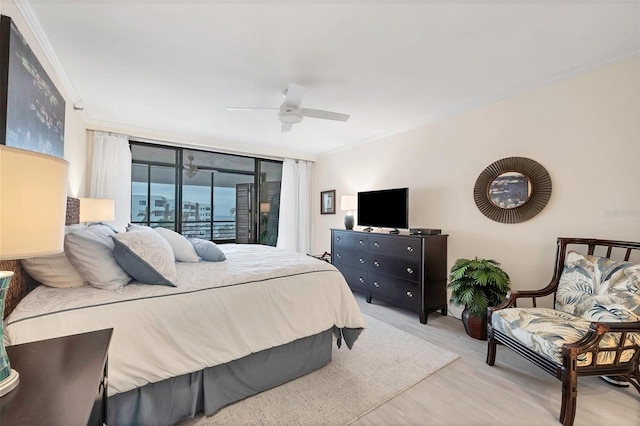 bedroom with a wall of windows, access to outside, ornamental molding, ceiling fan, and light hardwood / wood-style flooring