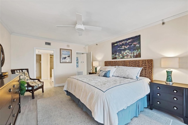 bedroom with ceiling fan, crown molding, and light hardwood / wood-style flooring