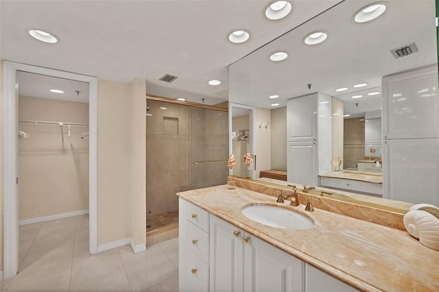 bathroom with vanity, tile patterned flooring, and an enclosed shower