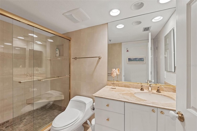 bathroom featuring tile walls, walk in shower, vanity, and toilet