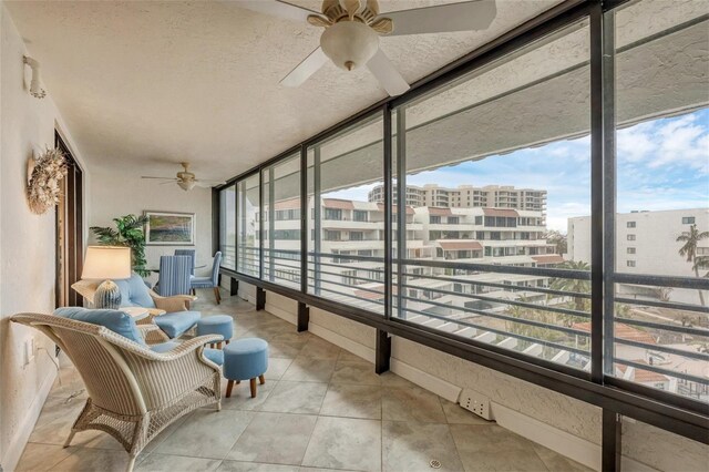 sunroom / solarium with ceiling fan and a wealth of natural light