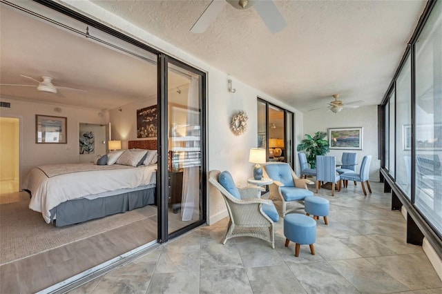 sunroom featuring ceiling fan