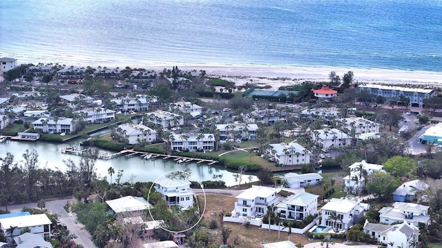 bird's eye view featuring a view of the beach and a water view