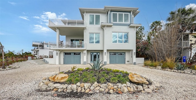 view of front of property featuring a balcony and a garage