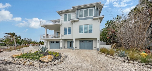 view of front of home with a garage and a balcony