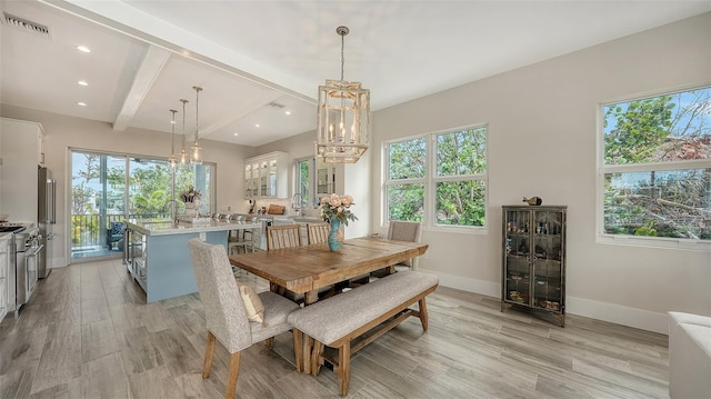 dining space featuring light hardwood / wood-style flooring, beam ceiling, and plenty of natural light