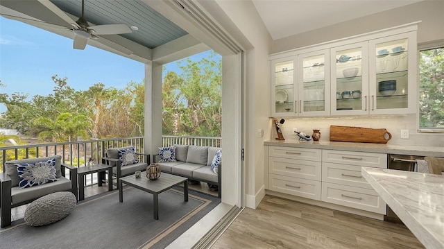 sunroom featuring ceiling fan