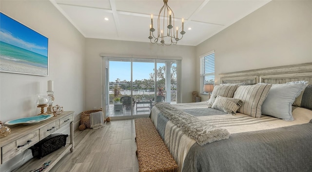 bedroom featuring light hardwood / wood-style flooring, access to outside, and a notable chandelier