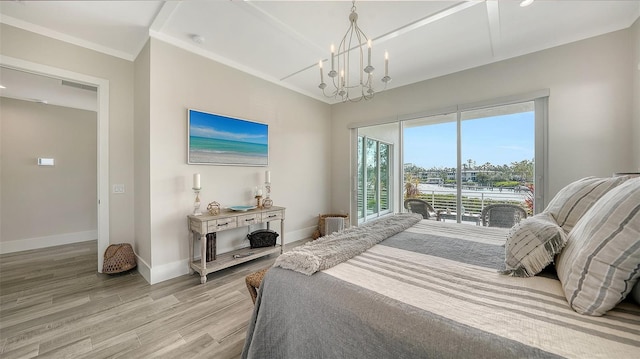 bedroom featuring access to exterior, ornamental molding, light hardwood / wood-style flooring, and a notable chandelier