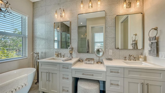 bathroom with a tub, tile walls, and plenty of natural light