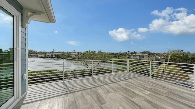 wooden terrace featuring a water view