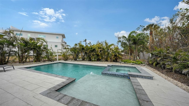 view of pool featuring an in ground hot tub and a patio