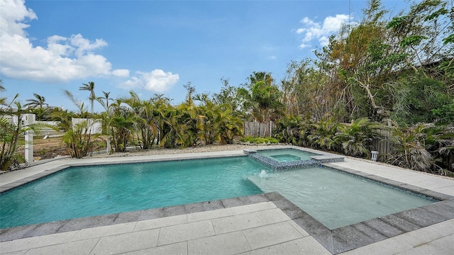 view of swimming pool featuring an in ground hot tub