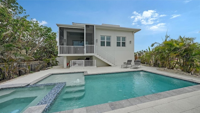 back of house with a patio, a fenced in pool, and a sunroom