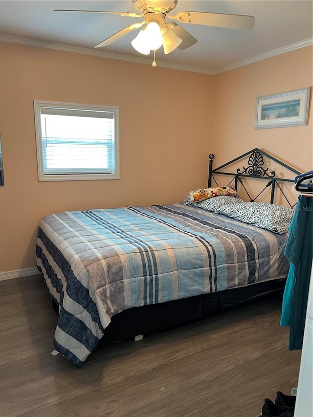 bedroom with dark wood-type flooring, ceiling fan, and crown molding