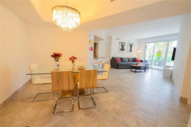 dining space featuring light tile patterned floors and a notable chandelier