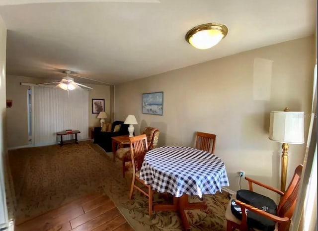 dining space featuring ceiling fan and hardwood / wood-style floors