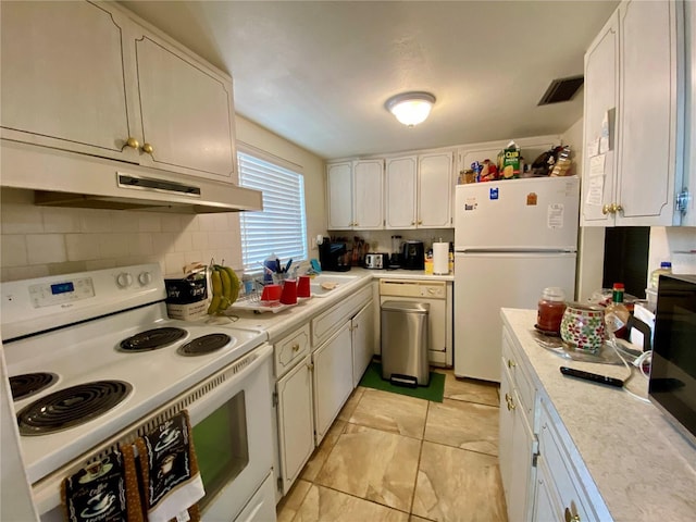 kitchen featuring white appliances, white cabinets, backsplash, and sink