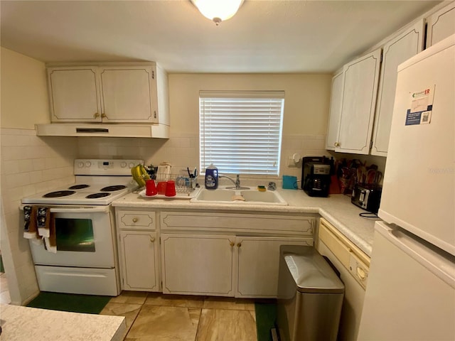 kitchen with white appliances, decorative backsplash, and sink