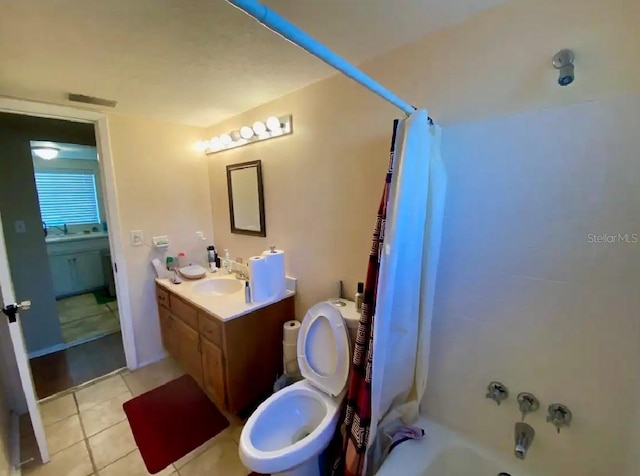 full bathroom featuring toilet, tile patterned flooring, shower / bath combo, and vanity