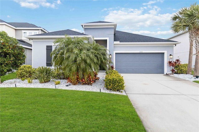 view of front of home with a front yard and a garage