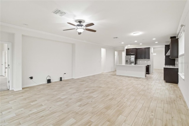 unfurnished living room with ornamental molding, ceiling fan, and light wood-type flooring