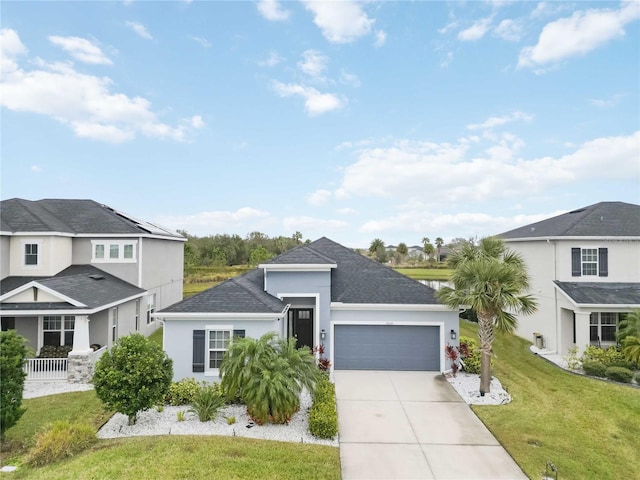 view of front of property featuring a front yard and a garage