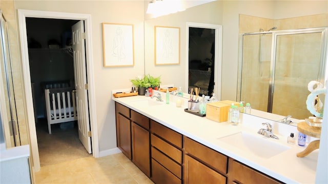 bathroom with tile patterned floors, a shower with door, and vanity