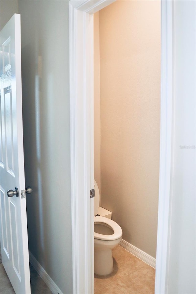 bathroom with toilet and tile patterned flooring